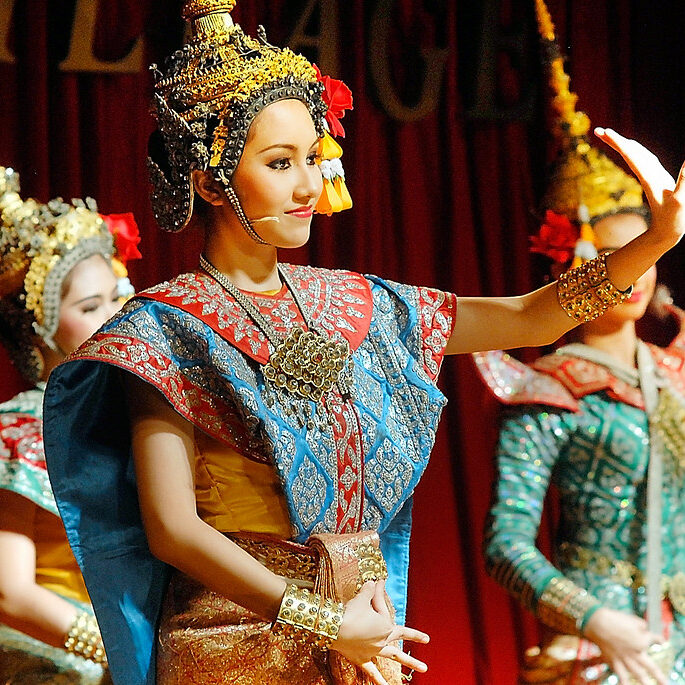 Traditional Thai dancers performing on stage — authentic cultural experiences for impactful team events.