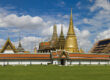 Iconic view of the Grand Palace complex in Bangkok under a bright blue sky, representing the blend of tradition and modernity that makes hybrid team-building programs effective in Thailand’s capital.