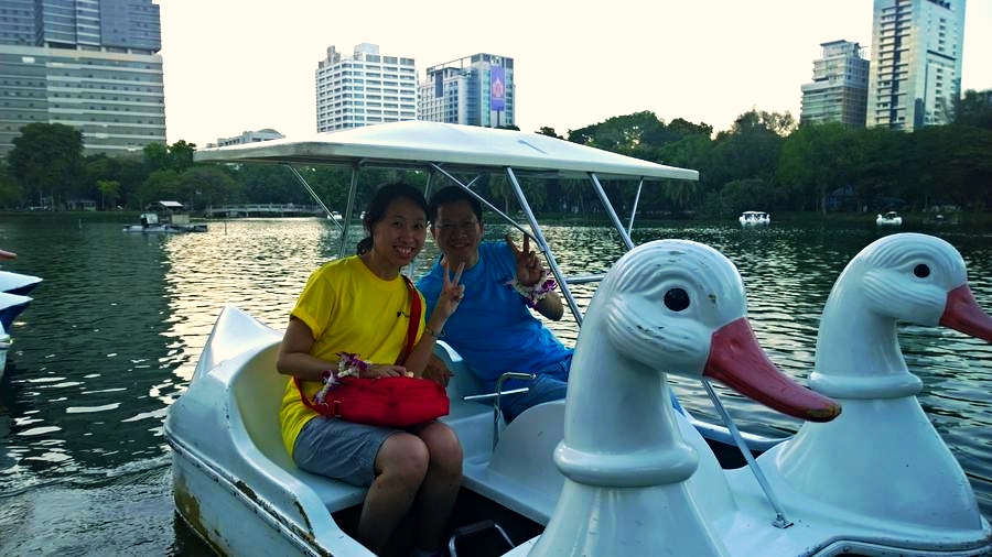 Logistics Onboard Coordination Team members coordinating logistics while enjoying a paddle boat ride in a Bangkok park.