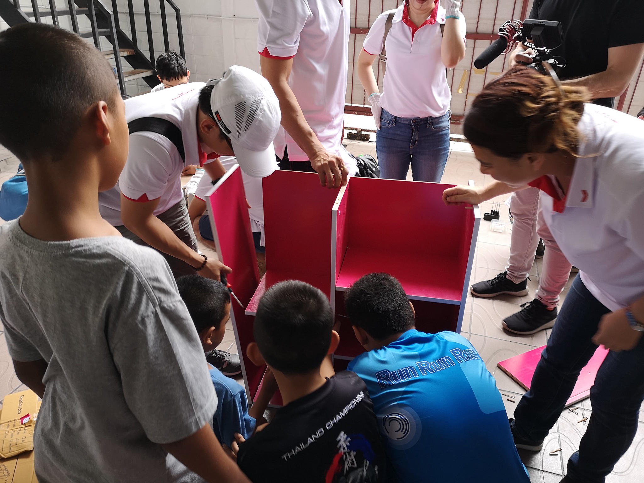 Building Furniture with Purpose CSR team building activity: employees building and donating furniture for a local community school