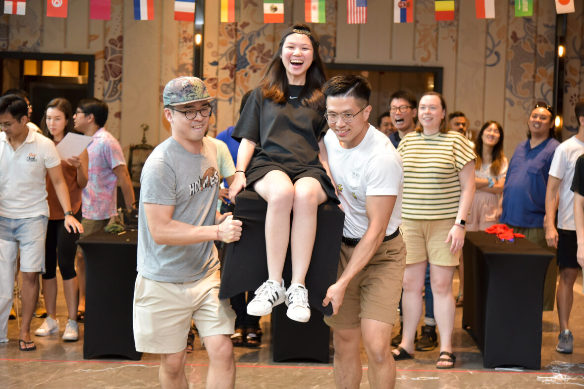 Team members celebrating success in a fun and engaging indoor team building activity in Phuket