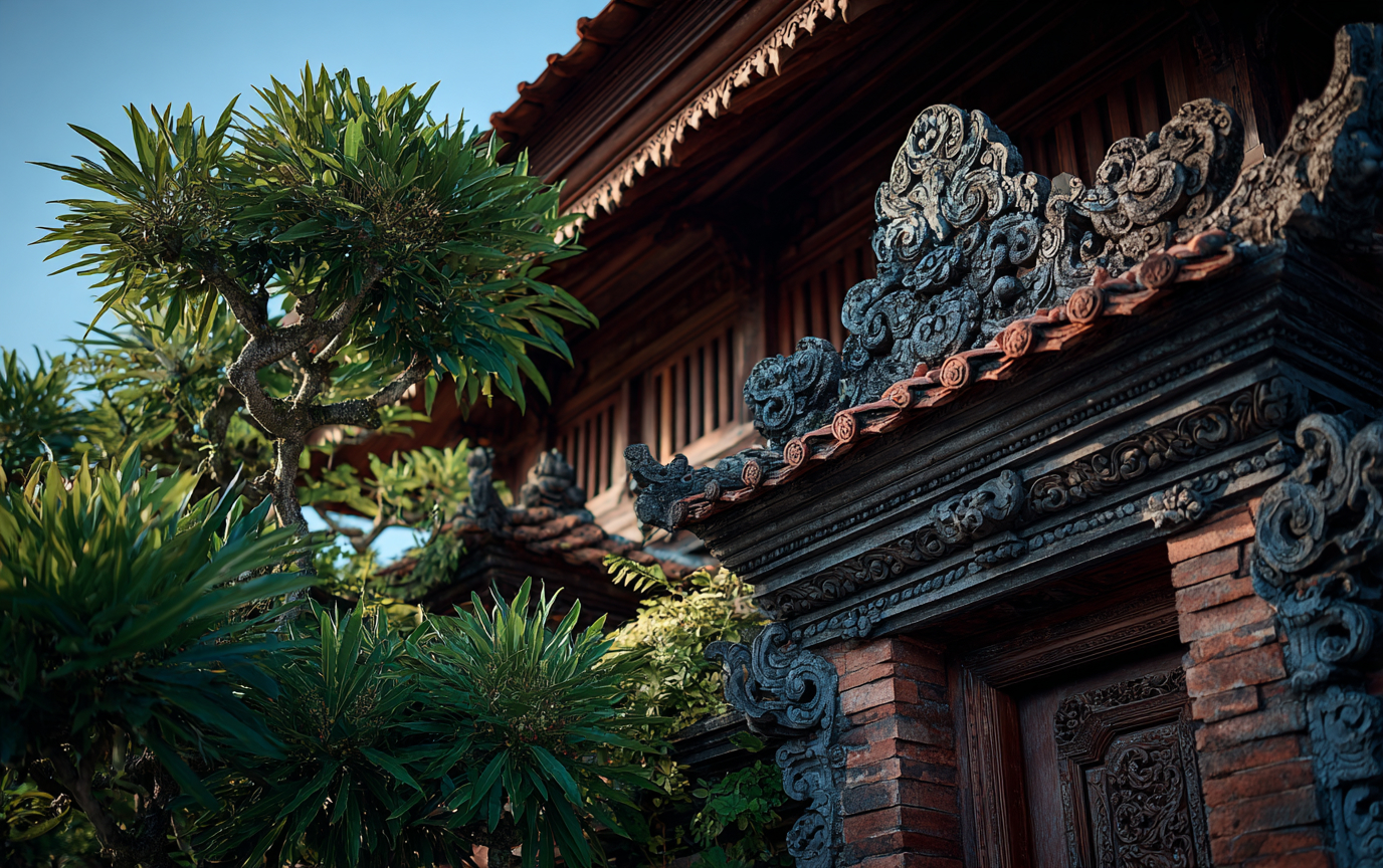 When Culture Shapes Creativity A traditional Balinese building with intricate stone carvings surrounded by lush greenery under a bright blue sky.