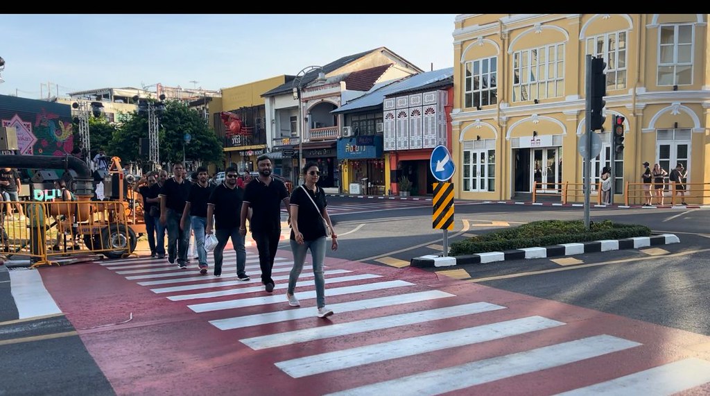 Why Mindful Travel Strengthens Teams Team members walking together through a historic city street, practicing mindful travel and shared awareness.