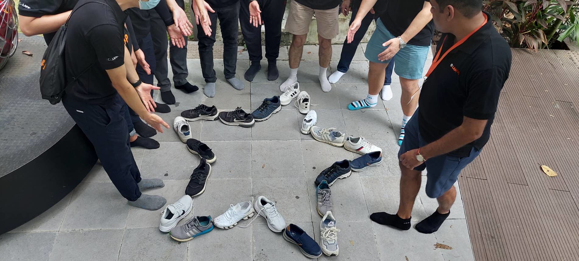 MakingTeamsโ Structured Approach in Bangkok Team members taking part in an outdoor collaborative challenge, following instructions and working together in a park environment.