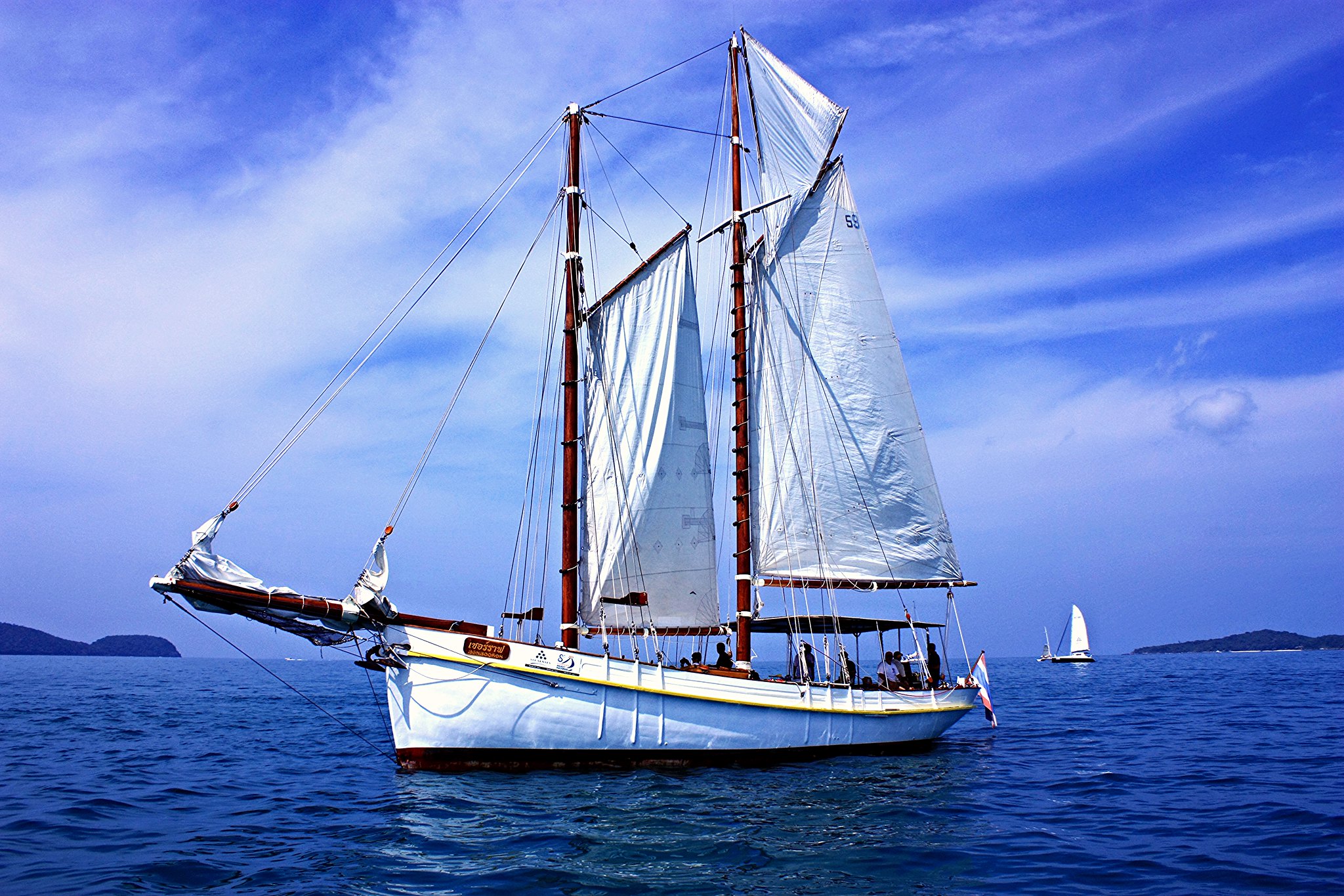 Sailing as a Powerful Platform for Team Development Corporate sailing team building experience in Phuket with a traditional sailboat on open water
