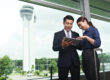 Business professionals reviewing venue options and strategic positioning plans in an urban setting in Thailand.