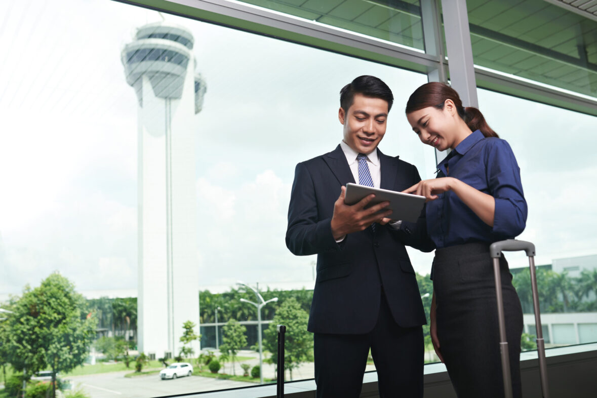Business professionals reviewing venue options and strategic positioning plans in an urban setting in Thailand.