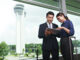 Business professionals reviewing venue options and strategic positioning plans in an urban setting in Thailand.