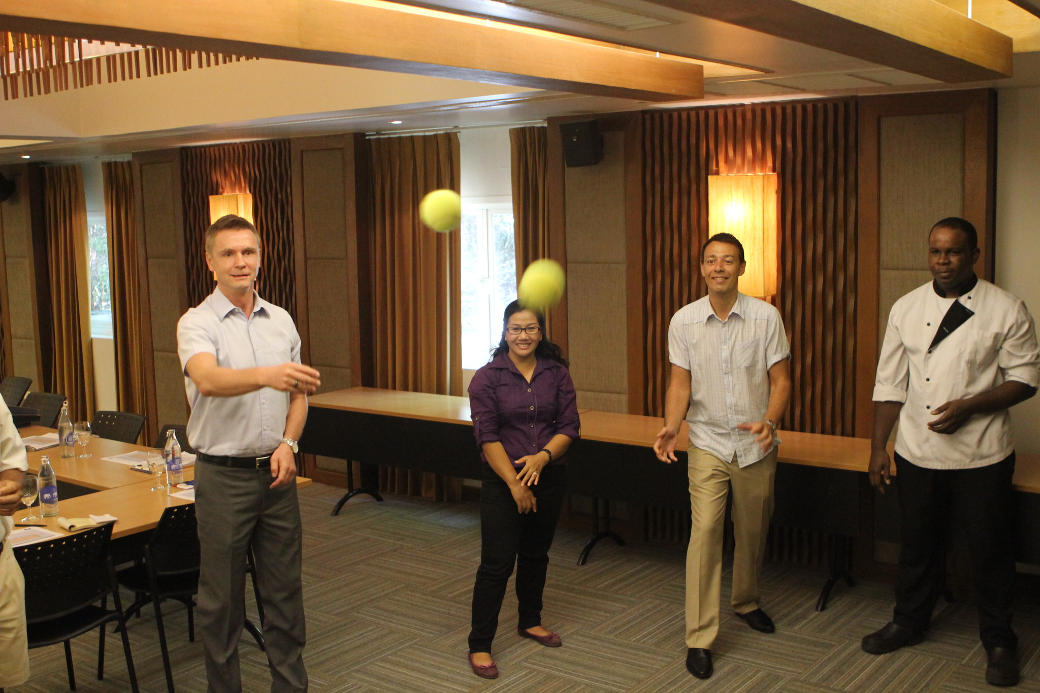 Operational Advantages of Indoor Team Building in Phuket Participants competing in a fast-paced problem-solving team challenge involving rings and targets during a corporate workshop.