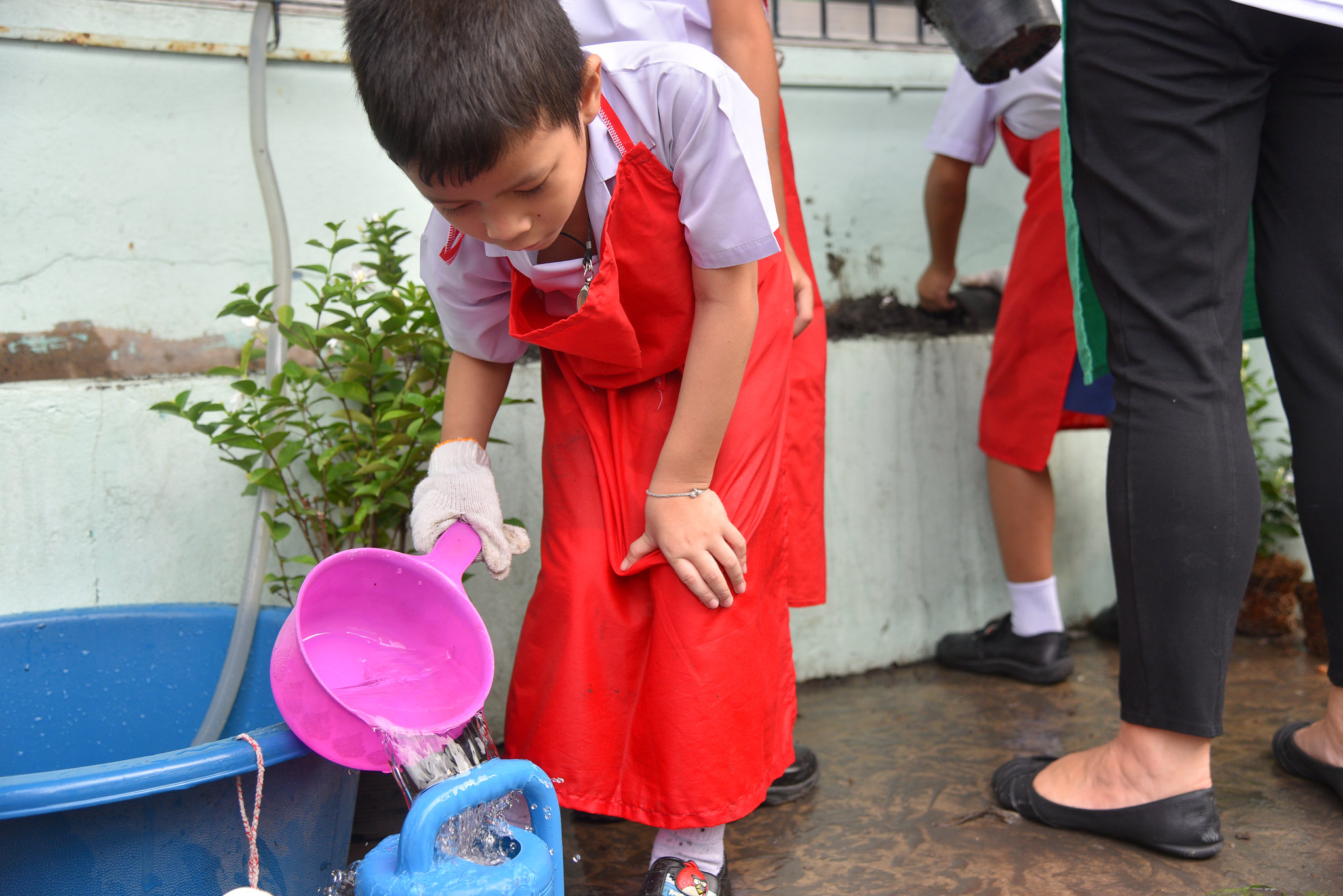 Bangkok Is an Ideal Destination for CSR Programs Child participating in hands-on activity during corporate CSR program focused on community development in Bangkok.