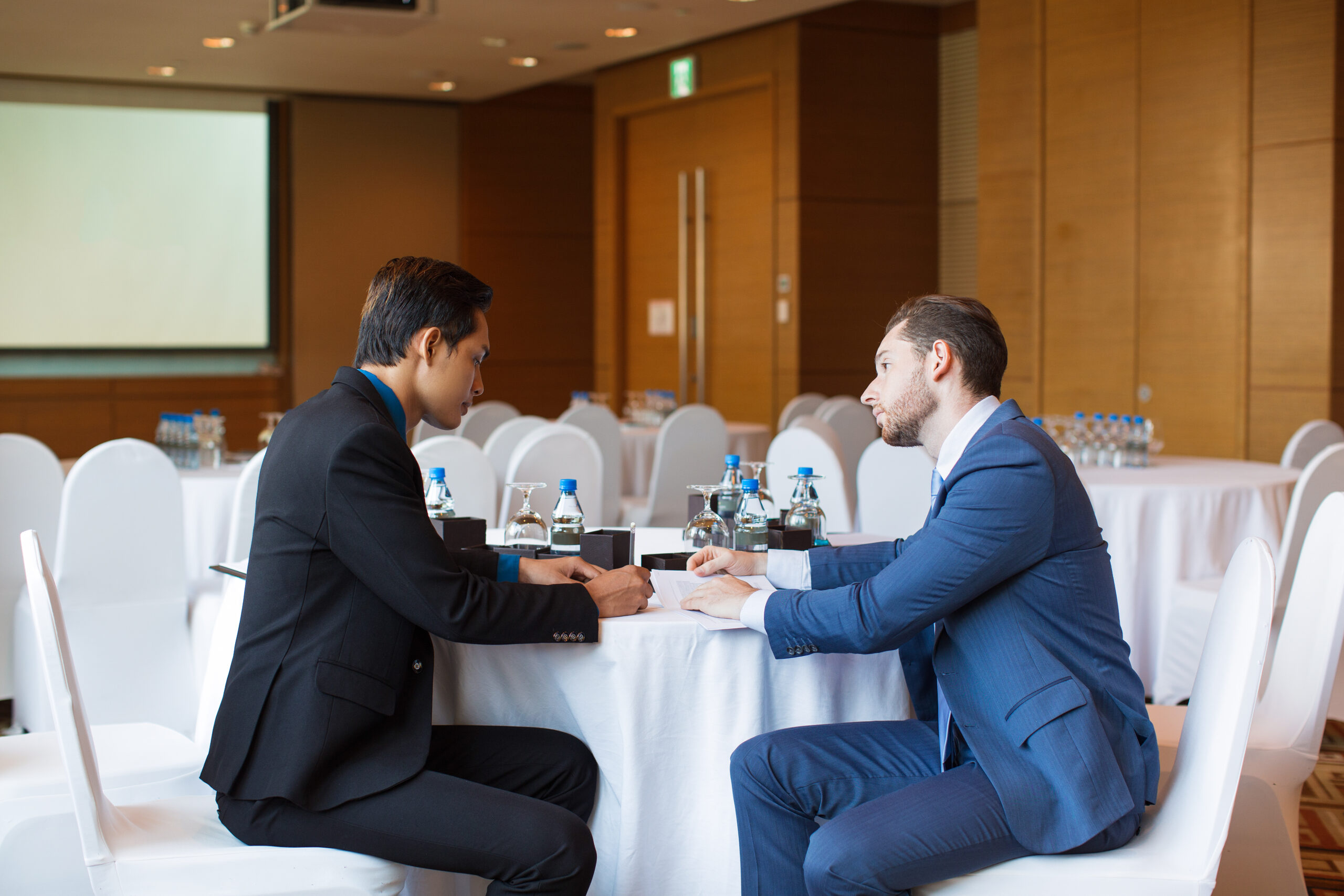 Two Serious Adult Business Men Discussing Issue End to end planning and on site coordination for business events