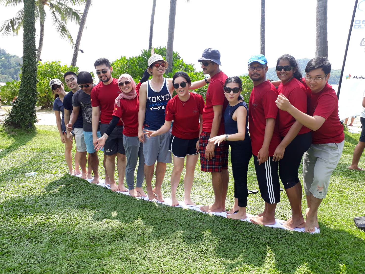 Corporate participants completing a large group beach team building activity that strengthens connection and team spirit