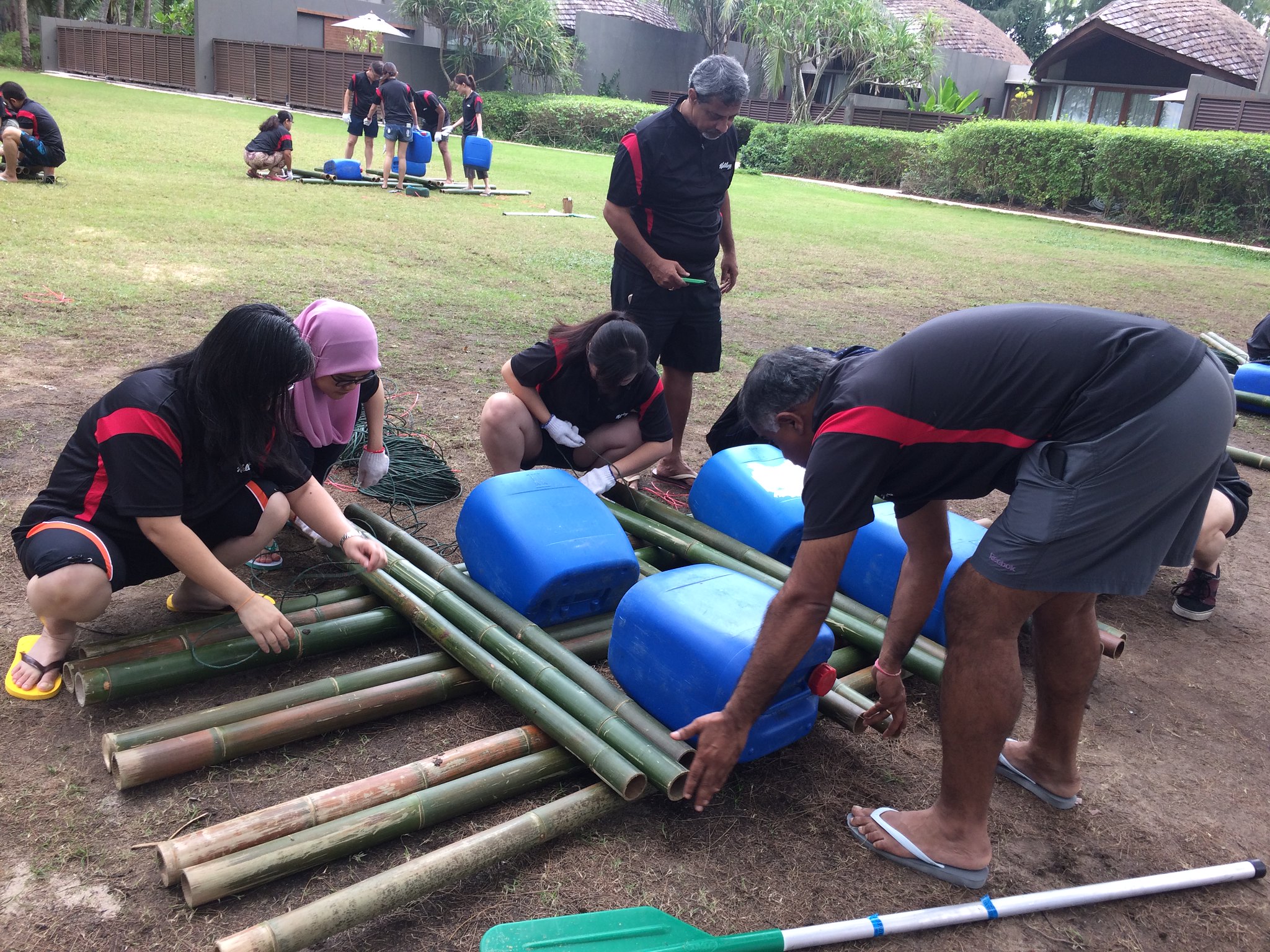 Planning Before Action Improves Team Performance Corporate team planning and assembling a bamboo raft to improve collaboration, communication, and team performance