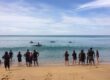 Teams launching handmade rafts during a collaborative raft-building team-building challenge on a Phuket beach