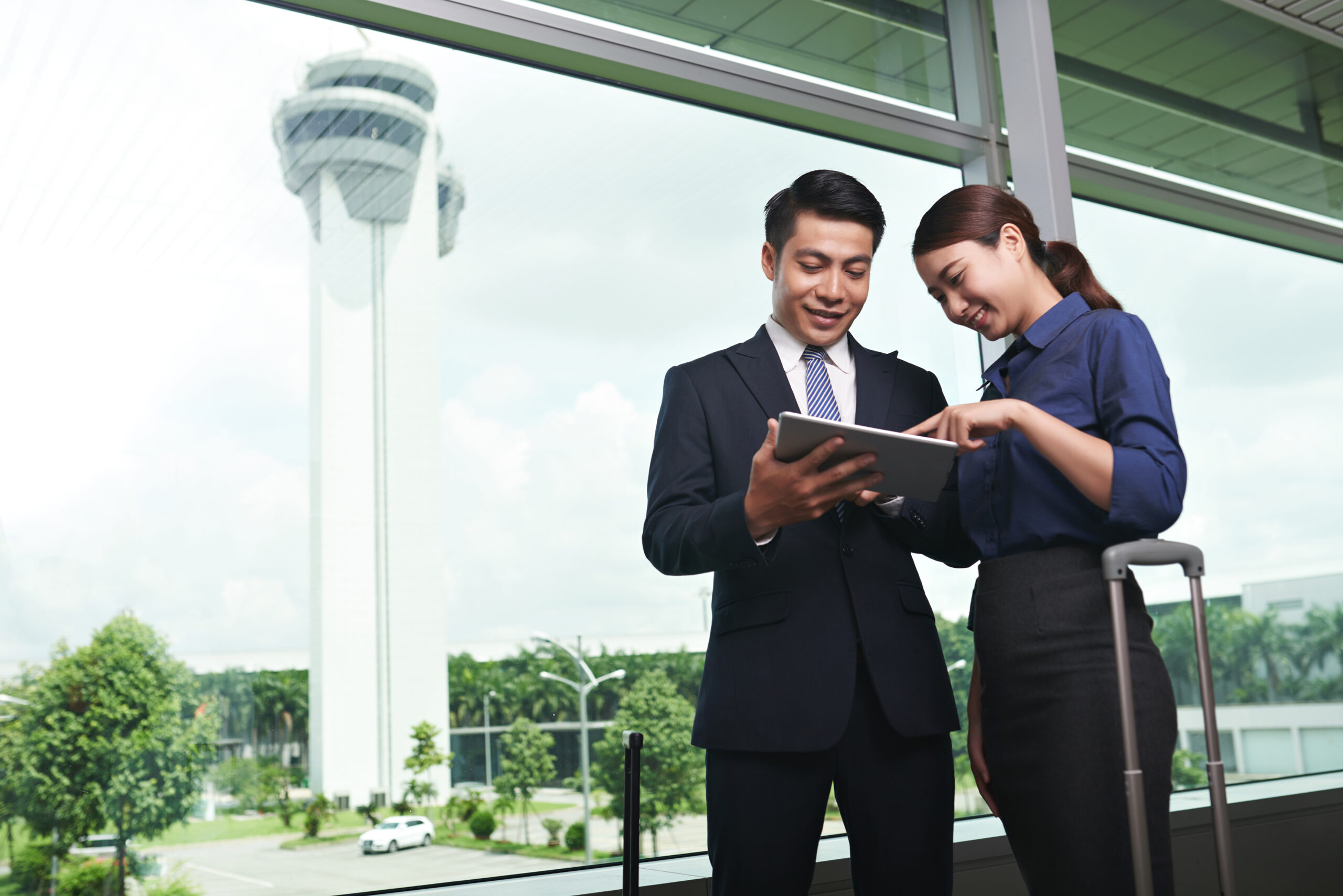 Asian Business People Landing in Airport Event professionals reviewing venue access, equipment delivery, and supplier schedules for a corporate event