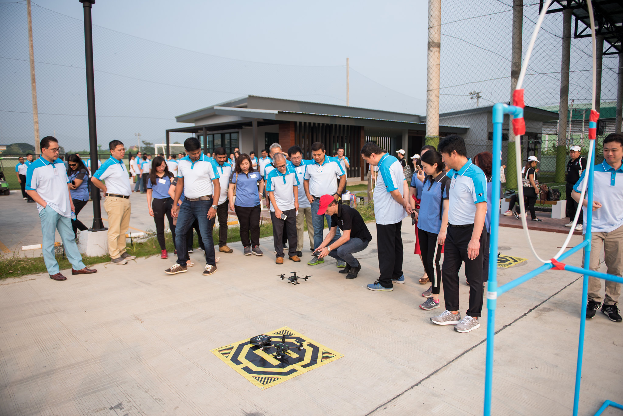 Corporate team participating in a drone mission challenge during a technology-focused team building event in Bangkok